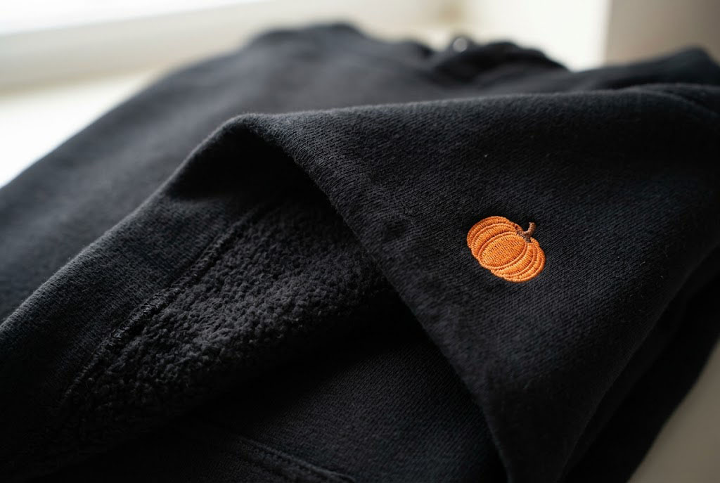 Close up macro shot of the fleece interior and heavy cotton exterior of a premium couples halloween hoodie